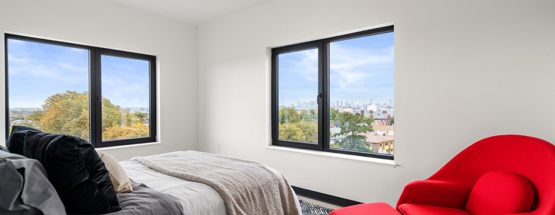 spacious bedroom with neighborhood views