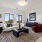 spacious living room with large widows next to bedroom